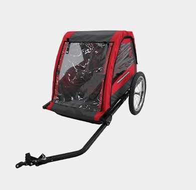 Red and black bicycle trailer with a clear rain cover and large wheels, isolated on a white background.